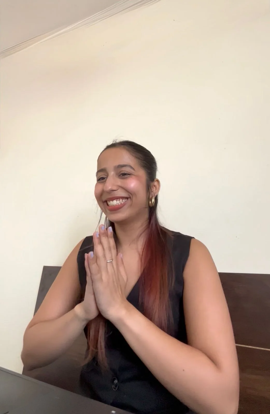 Saumya Smriti smiling while seated before a speaking session.